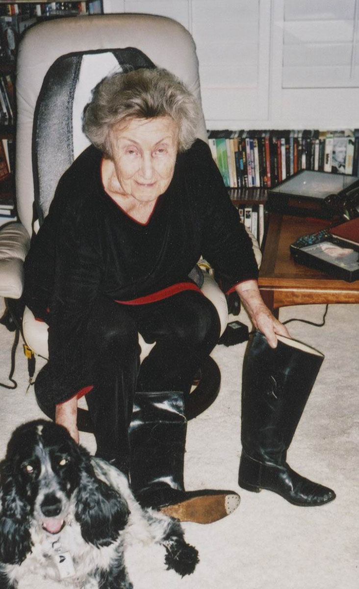 Mira Becker in her home when donating the boots to a representative of Yad Vashem